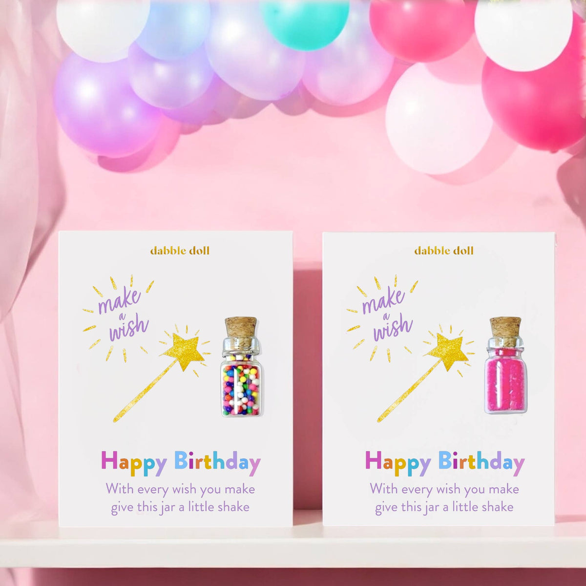 Two 'Happy Birthday' cards with colorful jars and stars against a pink background with balloons.