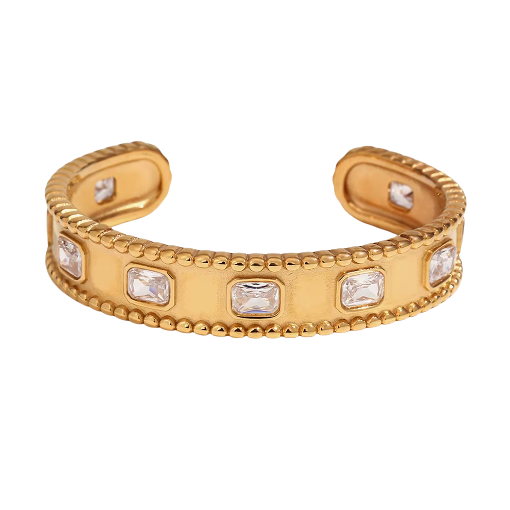 Gold bracelet with embedded crystals on a white background