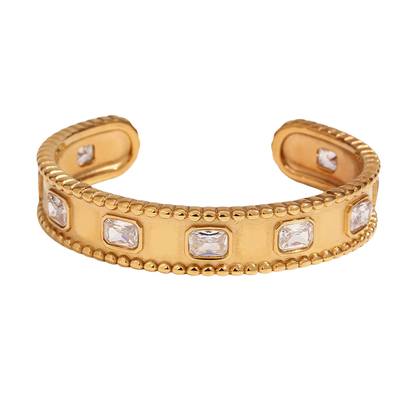 Gold bracelet with embedded crystals on a white background