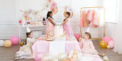 Children's birthday party with balloons and decorations in a room.